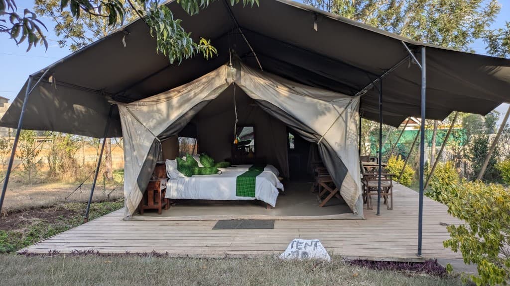 Ensuite safari tent on a wooden deck with beds visible inside